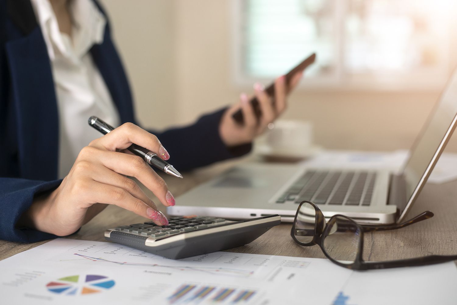 Close up of Accountant or Banker Making Calculations