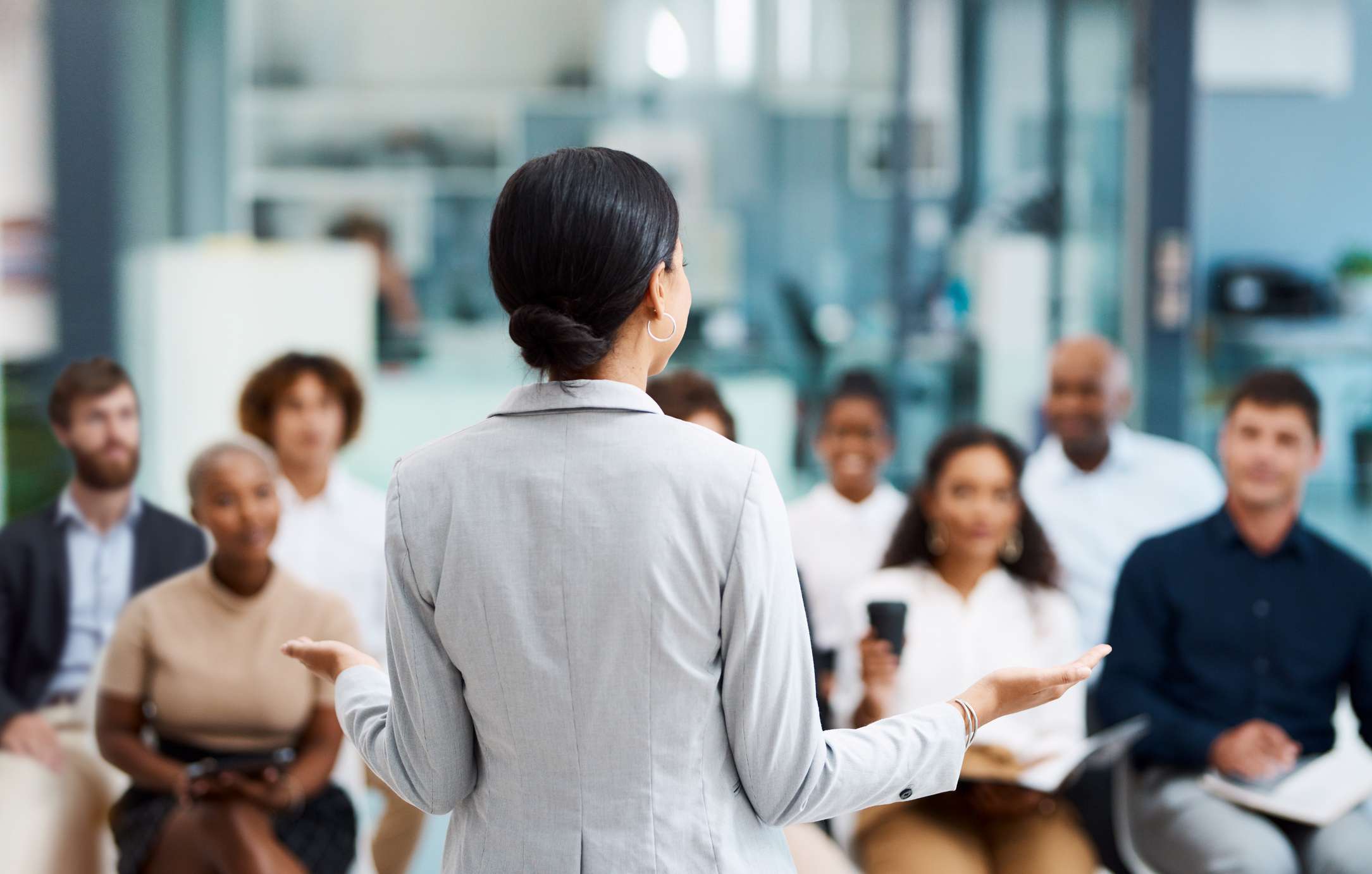 Rearview shot of an unrecognizable businesswoman giving a presentation in the office boardroom