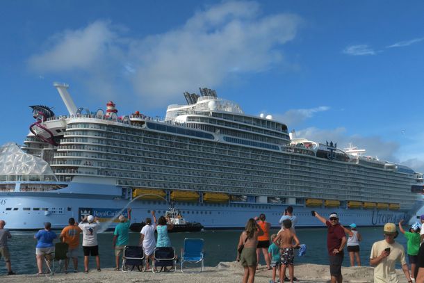 Spectators wave as Royal Caribbean's newest cruise ship, Utopia of the Seas, sails from Port Canaveral on its inaugural cruise with paying customers on July 19, 2024 in Port Canaveral, Florida.