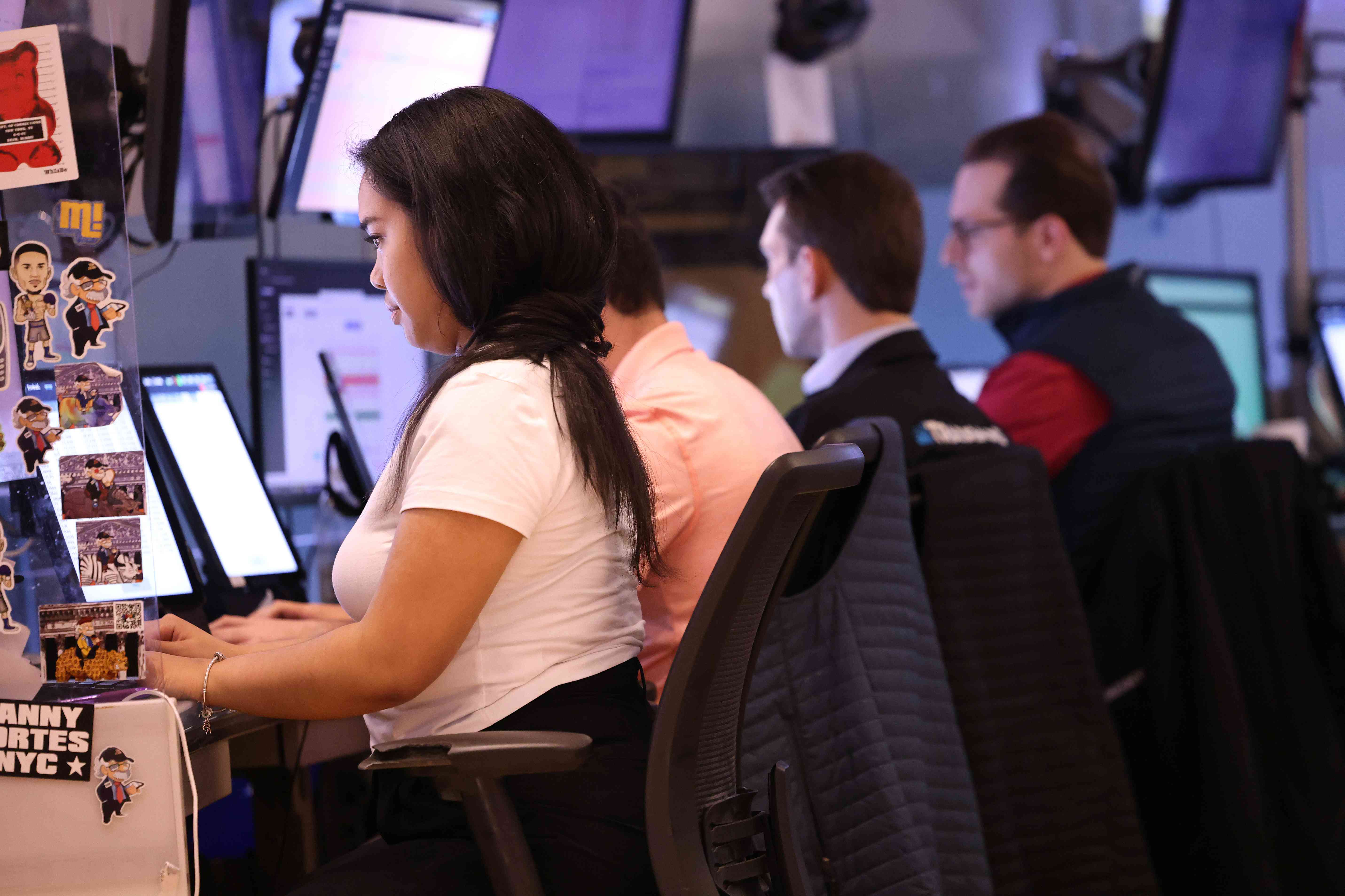 Traders at their computers working in the NYSE