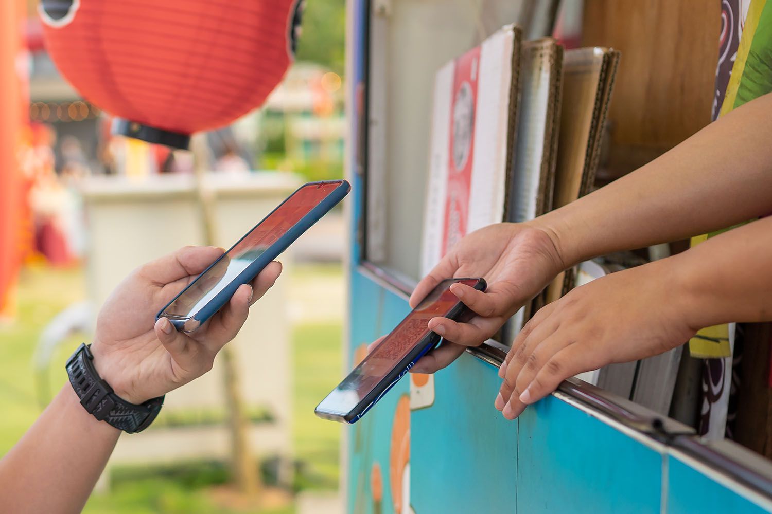 hand holding smartphone and scanning the barcode for contactless payment at the food truck