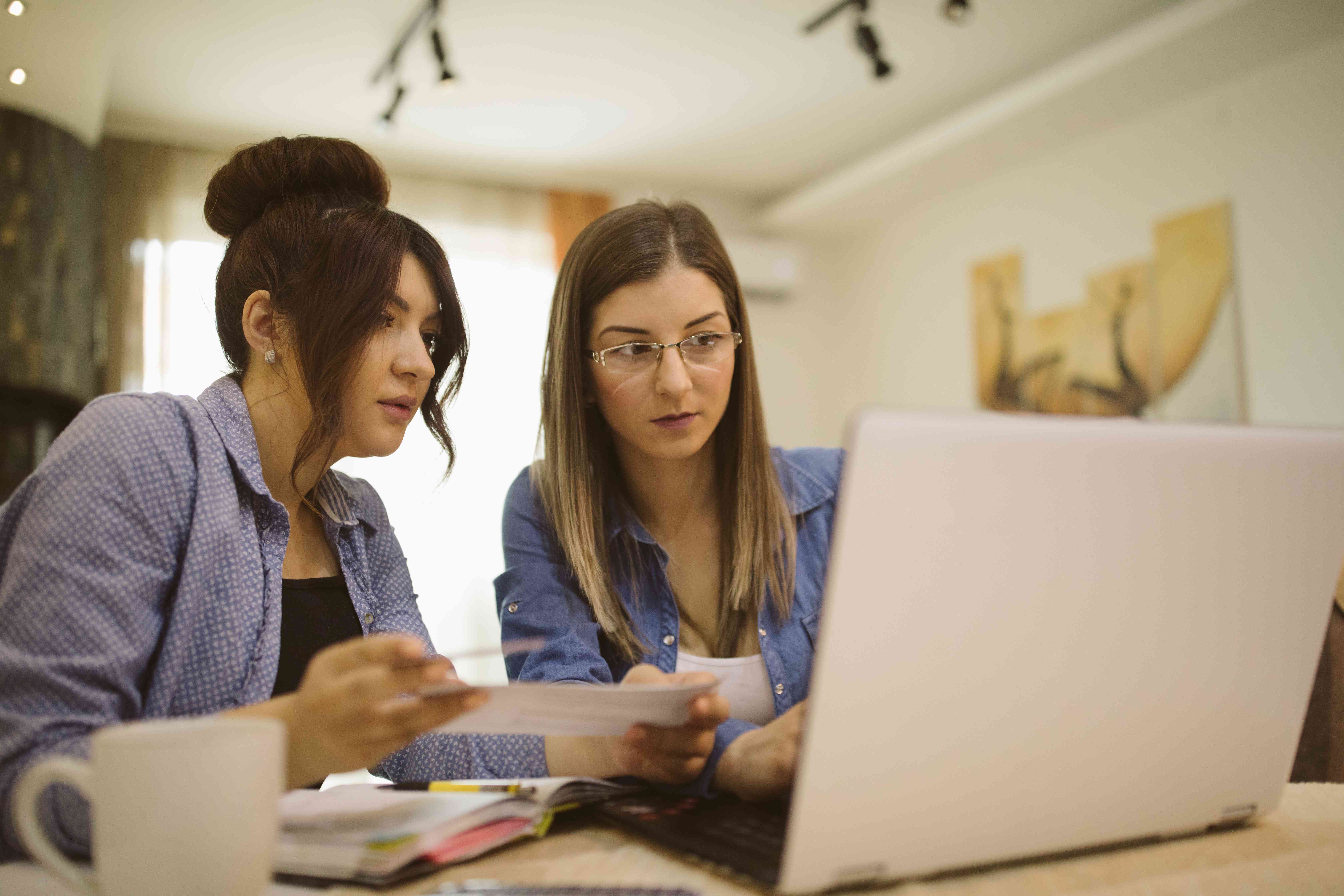 Friends sitting at home comparing deposit account options